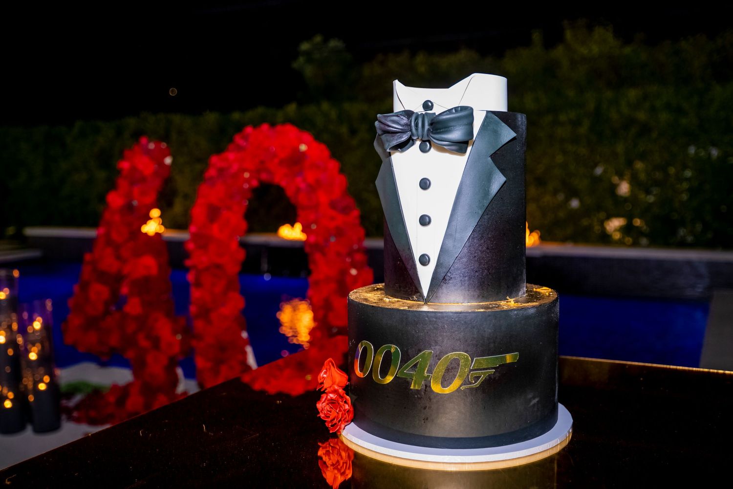 James Bond themed tuxedo wedding cake with white bow tie decoration.