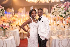 Elegant wedding reception with crystal chandeliers and warm amber lighting.