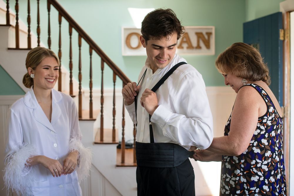 Wedding preparation scene with people getting ready indoors.