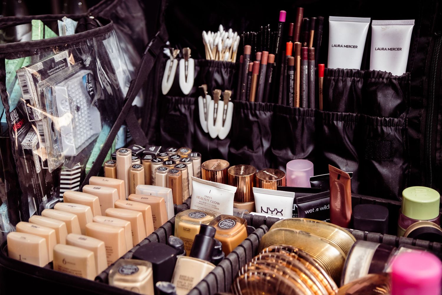 Professional makeup and beauty products neatly arranged on display table.