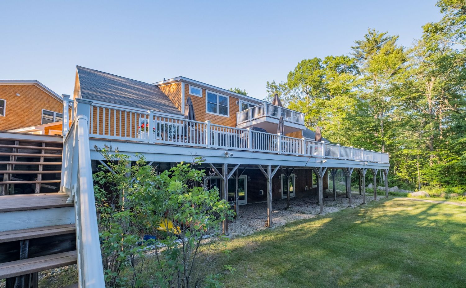 Exterior shot of extensive deck at vacation rental property in Harrison, Maine.