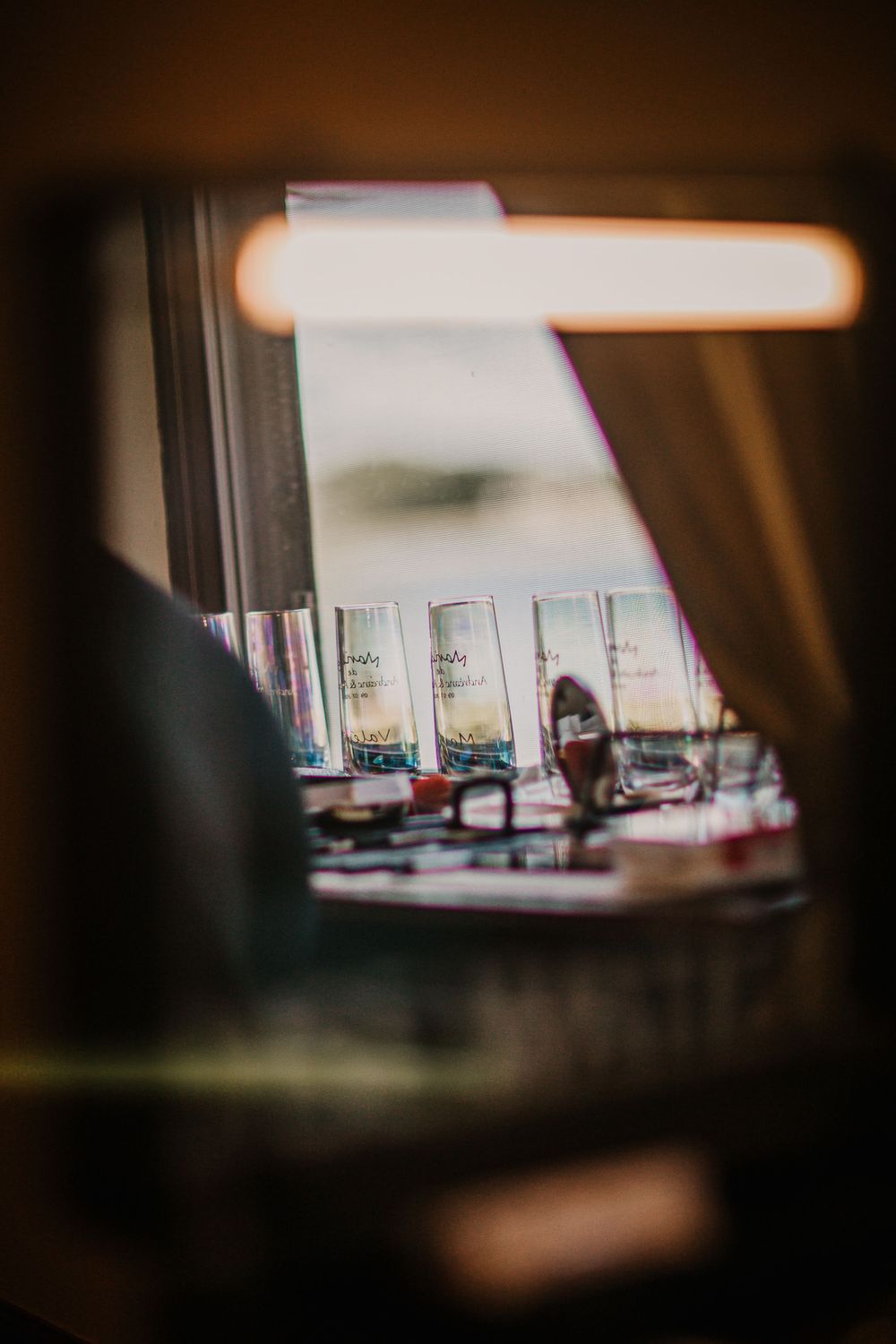 Blurred interior view through window with warm lighting and reflections.
