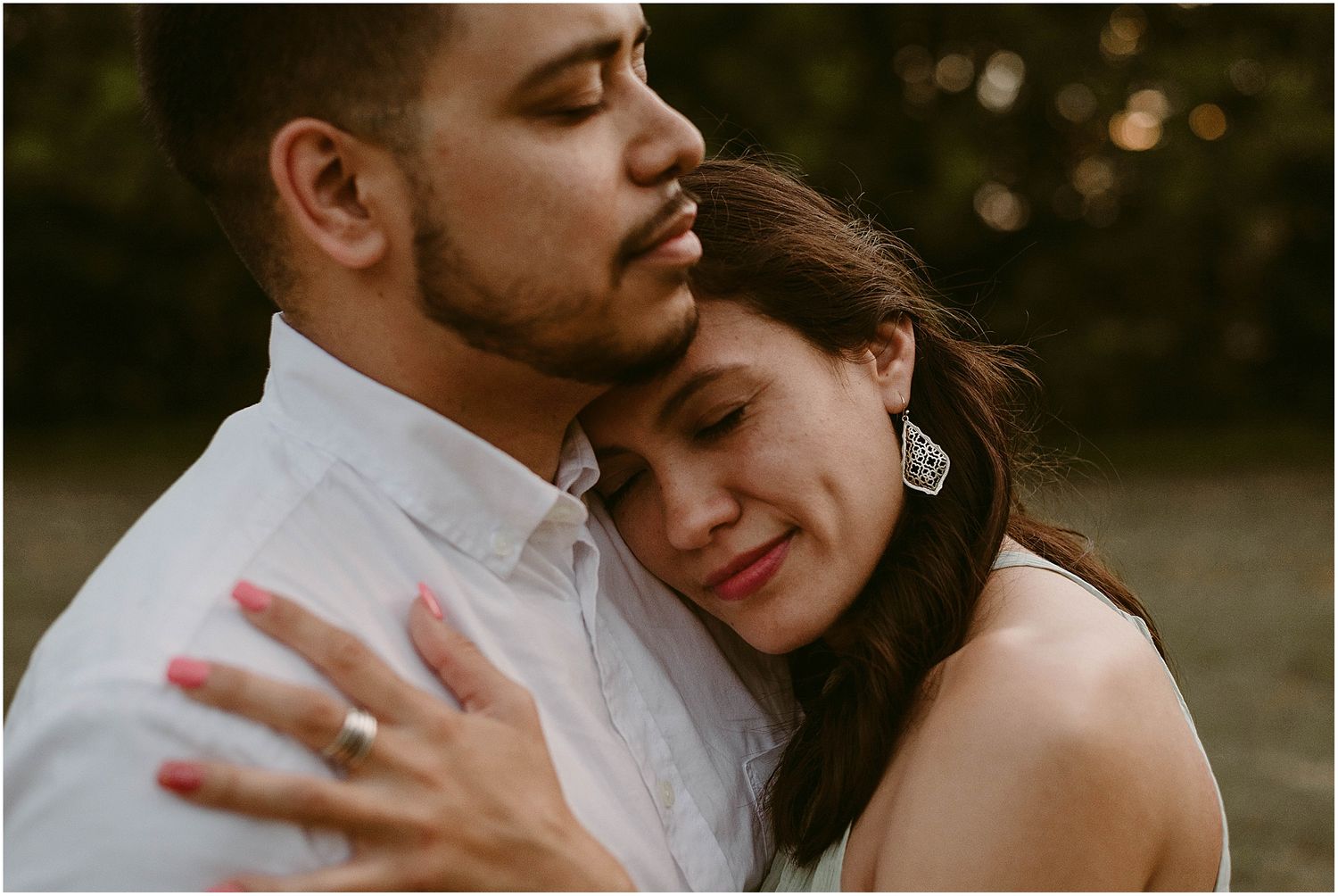 A tender moment between a couple as they embrace in warm evening light.