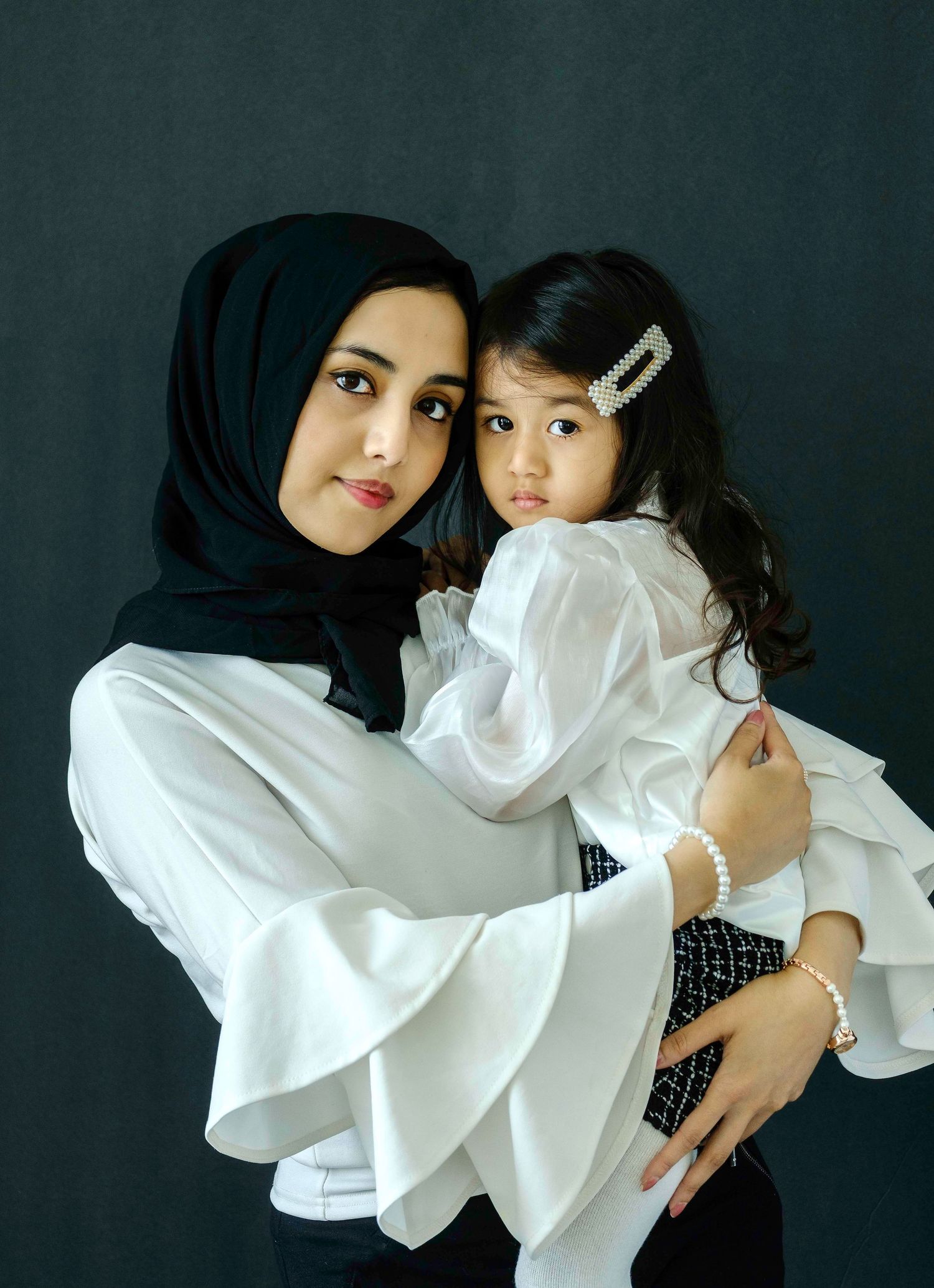Motherhood session with 5 year old daughter and her mother in queens photo studio.