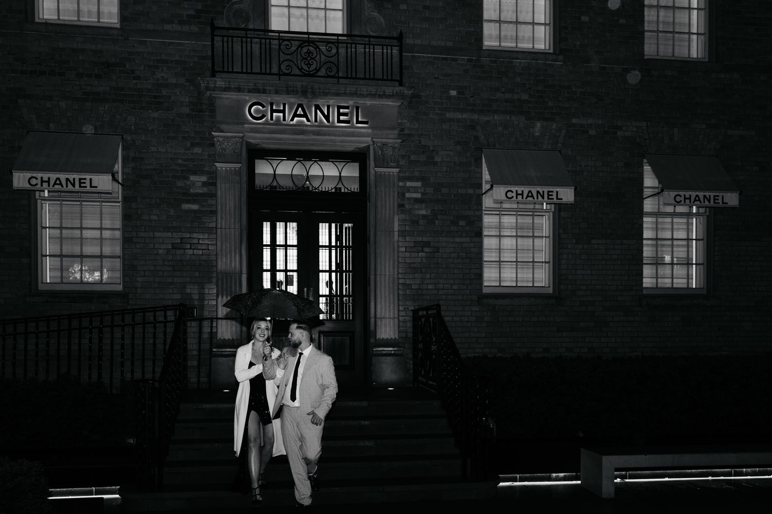 Black and white architectural exterior of Chanel store with classic window design.