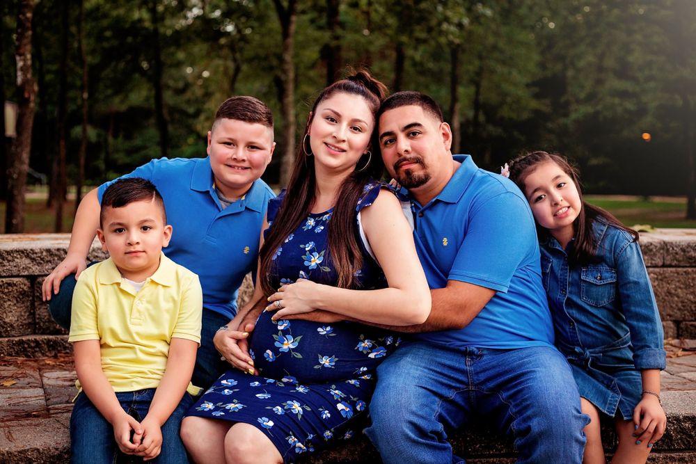 maternity portrait with family in spring blue and yellow colors posing together in Houston, Tx