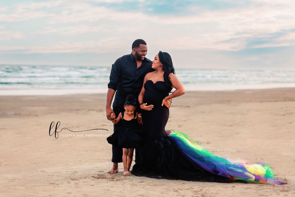 Maternity family portrait on the beach in Galveston, TX in black formal wear with rainbow accents.