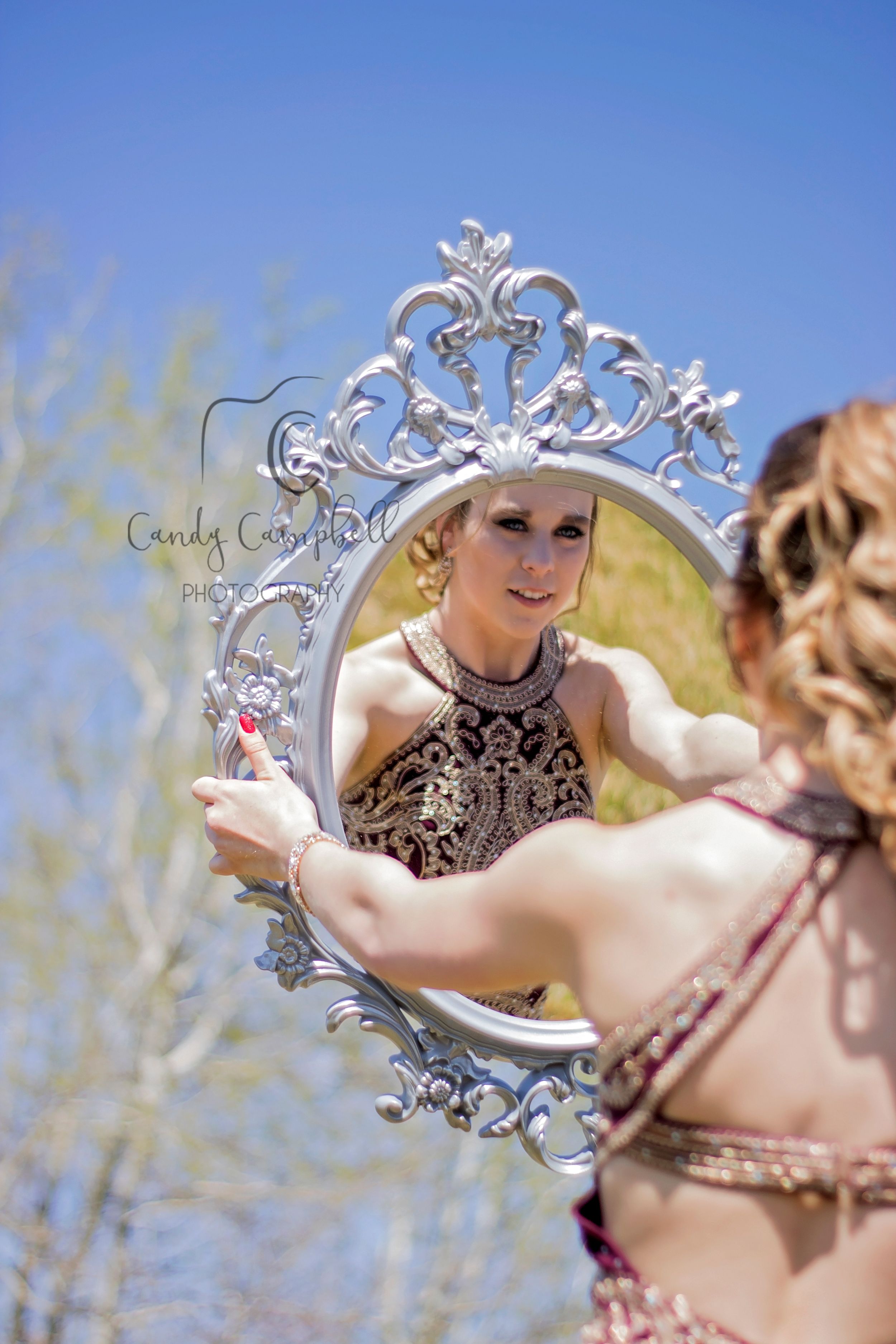 Senior Holding up a Mirror and looking at herself. Mannville, Alberta