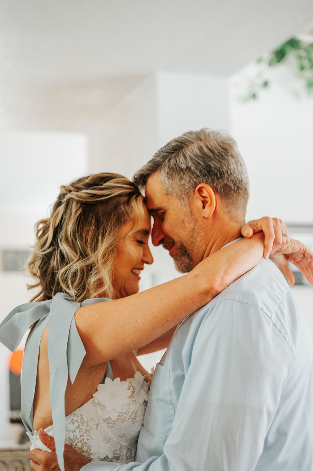 A romantic moment between a couple in wedding attire as they embrace.