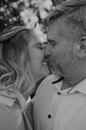 Black and white romantic close-up photos of an elderly couple sharing intimate moments together.