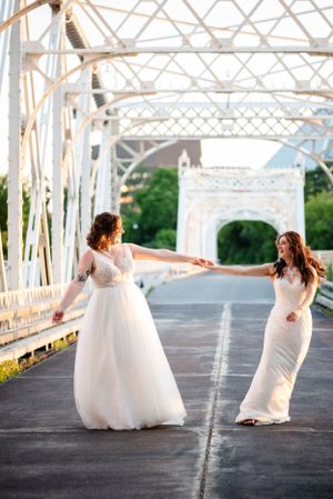 Two brides dancing on Minto Bridge in Ottawa