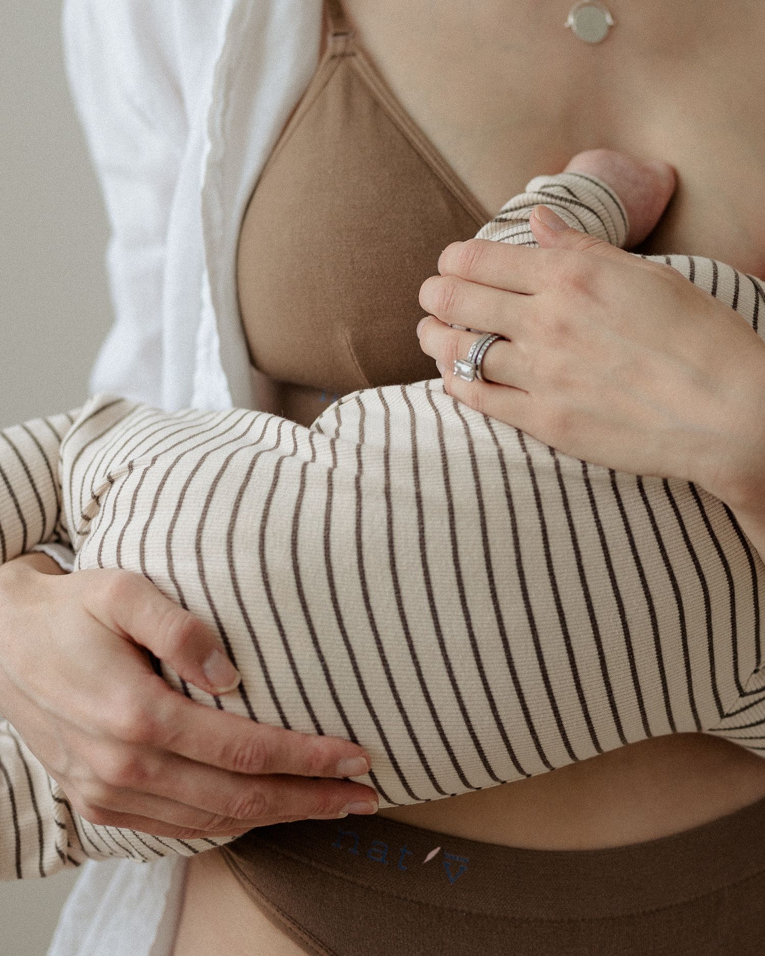 woman breastfeeding baby. comfortable breastfeeding bra