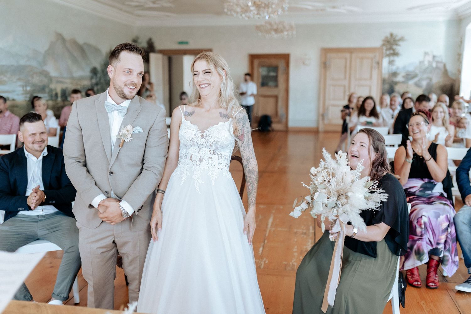 A bright indoor wedding ceremony scene with elegant decor and joyful atmosphere.