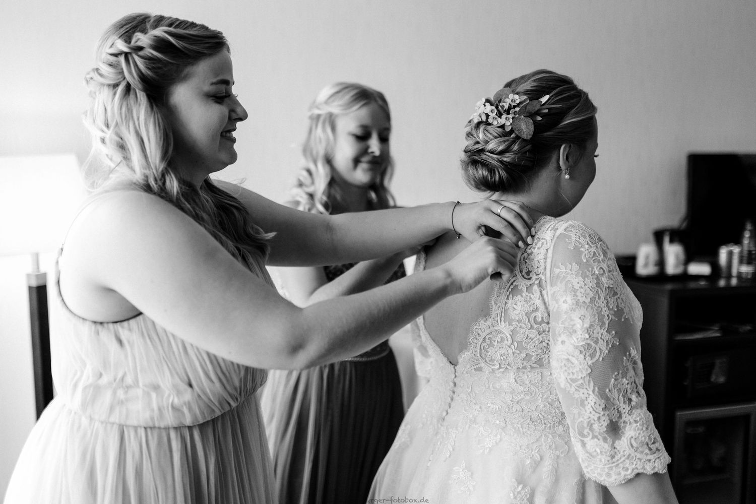 Behind the scenes of wedding preparations with dress and hair styling.