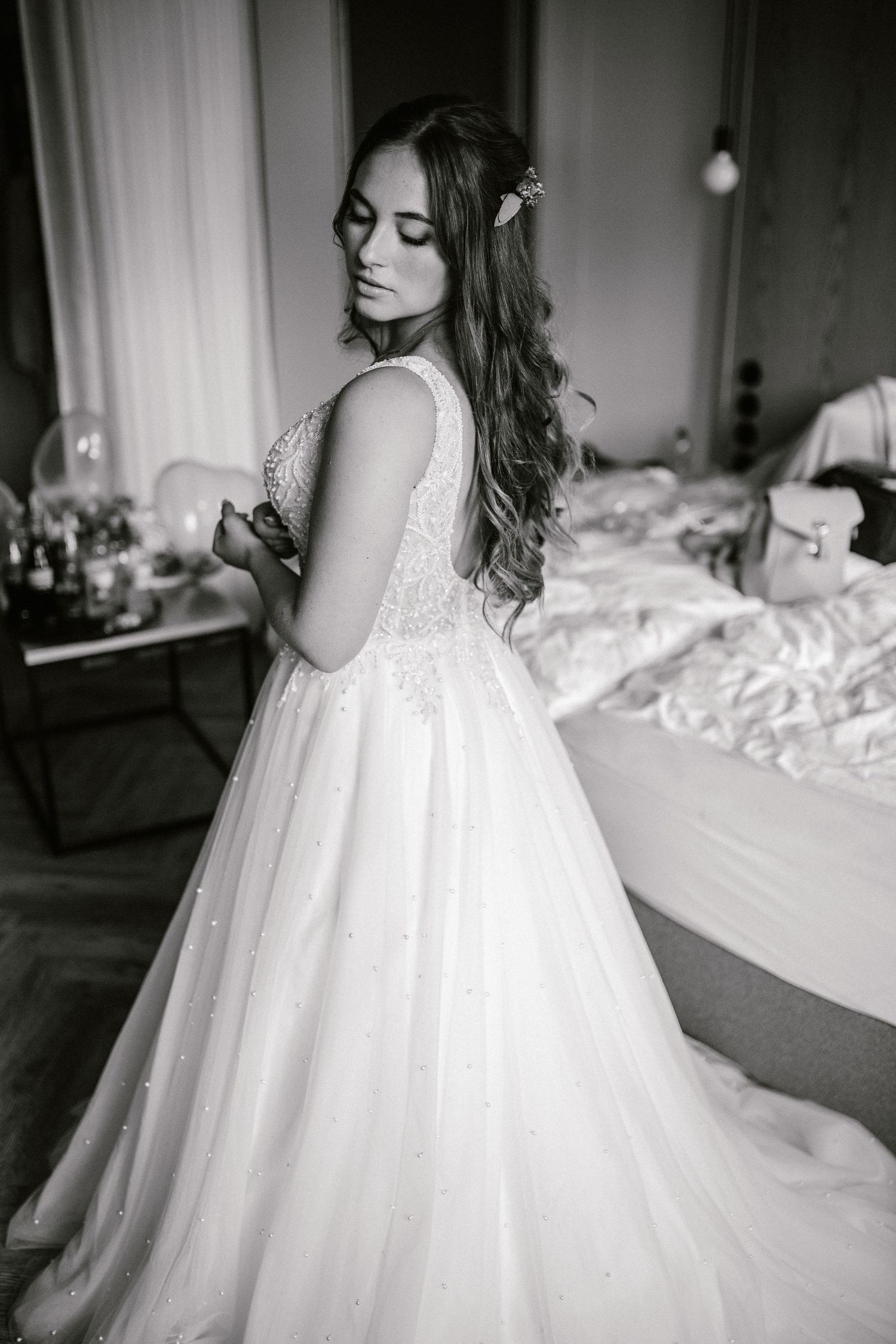 Classic black and white bridal portrait showing detailed lace wedding gown.
