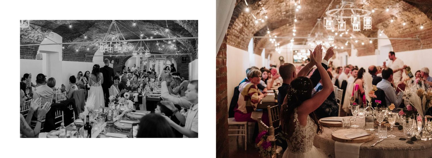 Wedding guests celebrate during a lively reception in a rustic venue adorned with string lights and chandeliers.