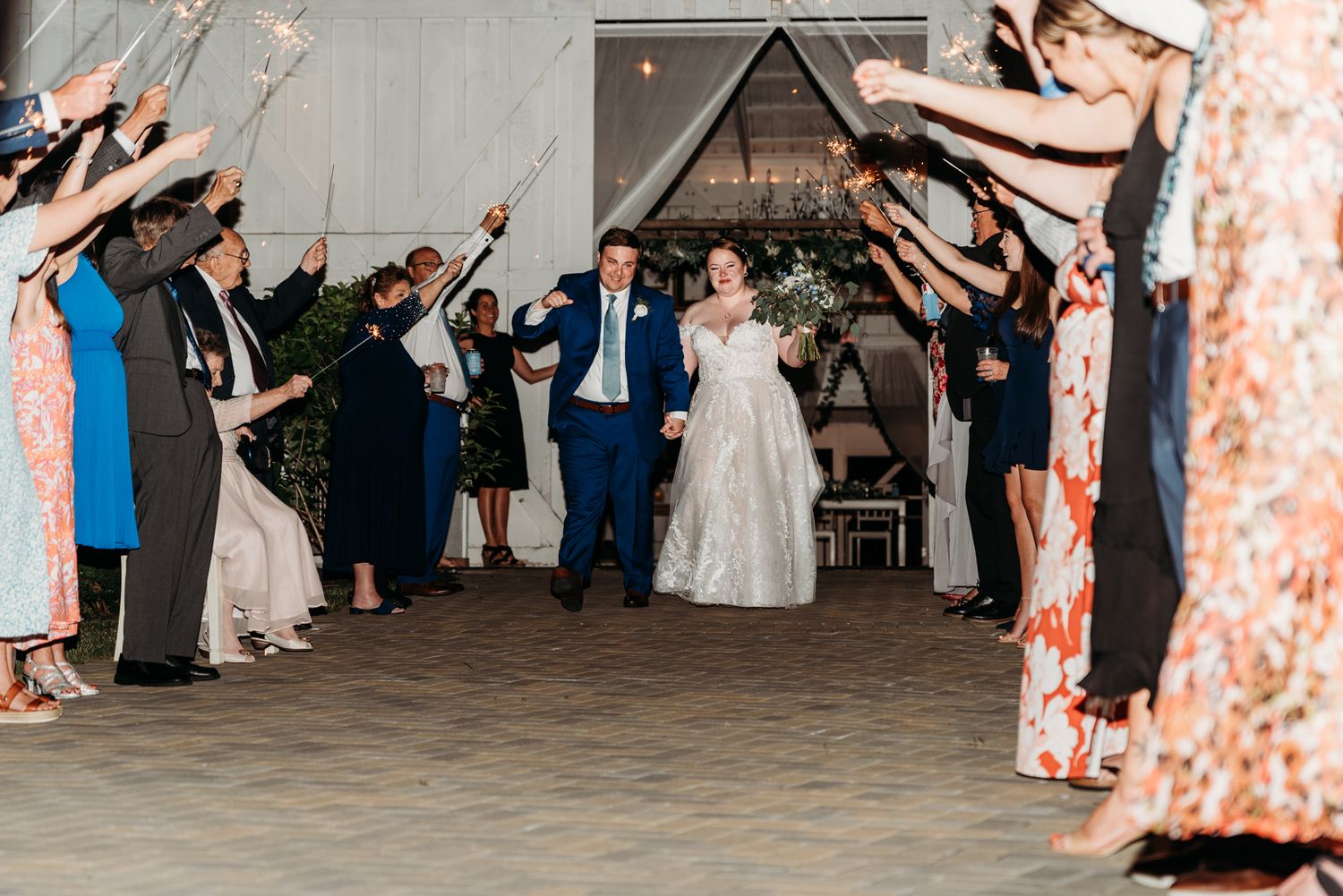 Bride and groom make their grand sparkler exit at The White Barn at Lucas Farms in Oakland, MD