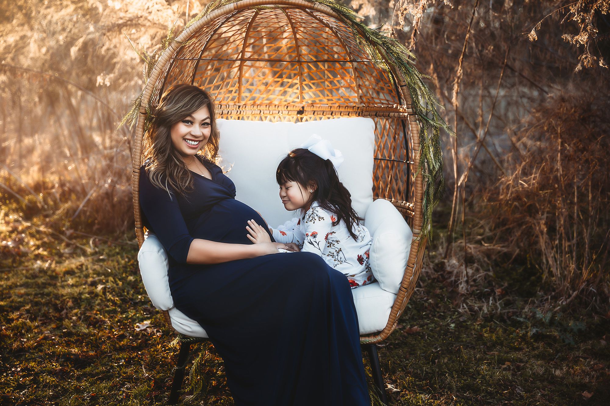 A cozy scene in a hanging rattan chair with cushions against a textured wall.