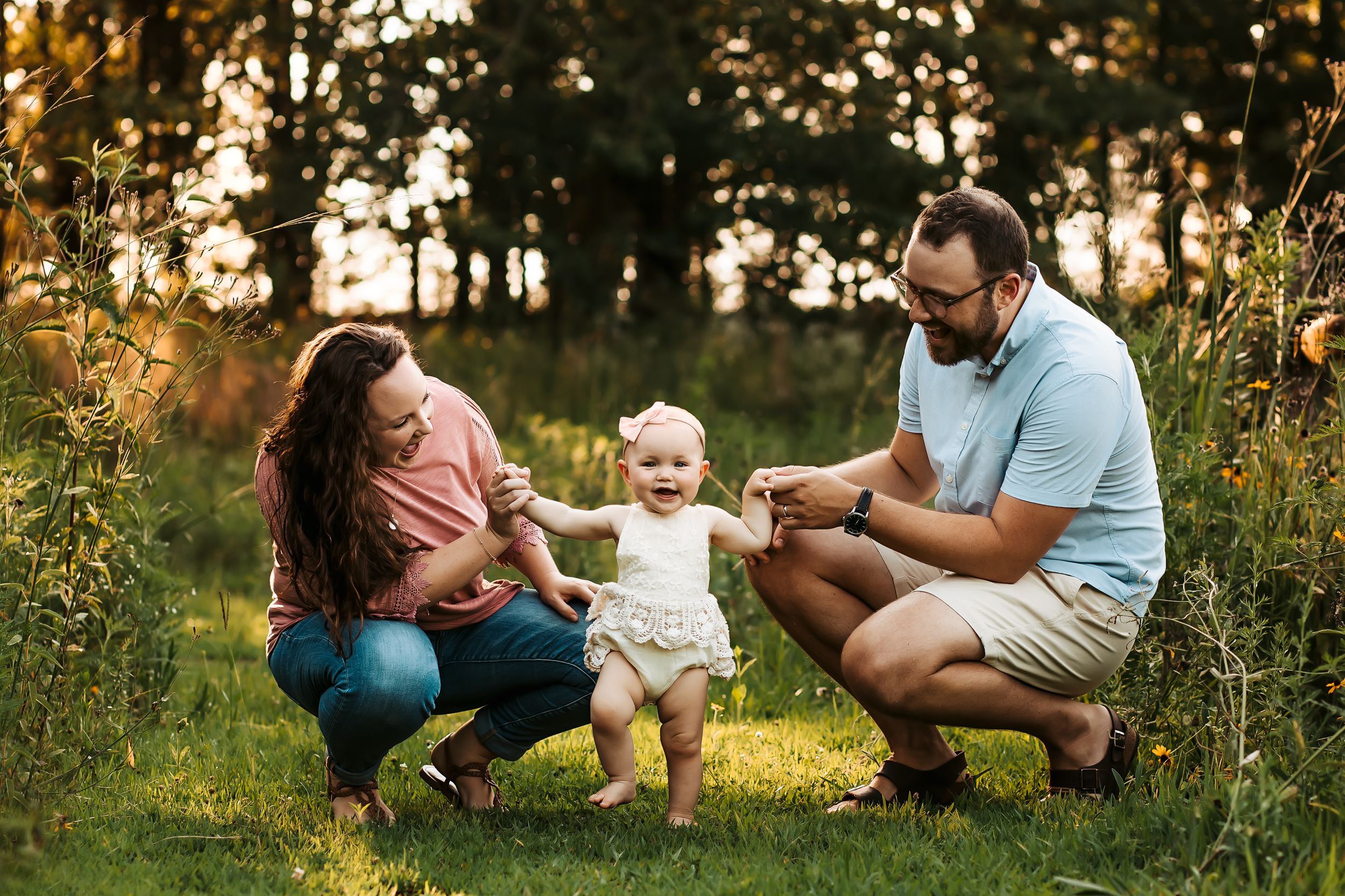 Family enjoying a sunny moment together in a field with golden sunlight.