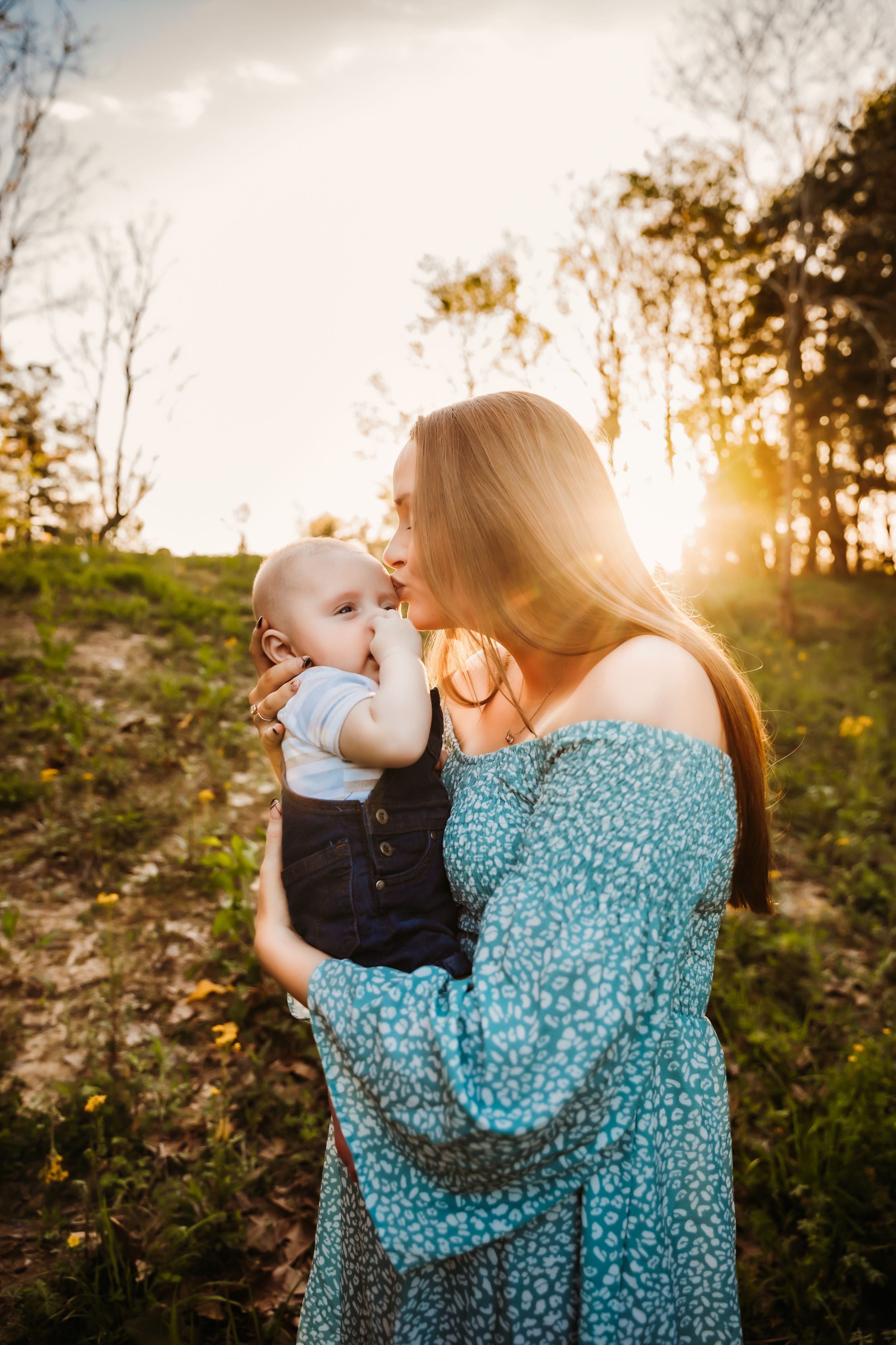 A backlit sunset portrait in a wooded setting.