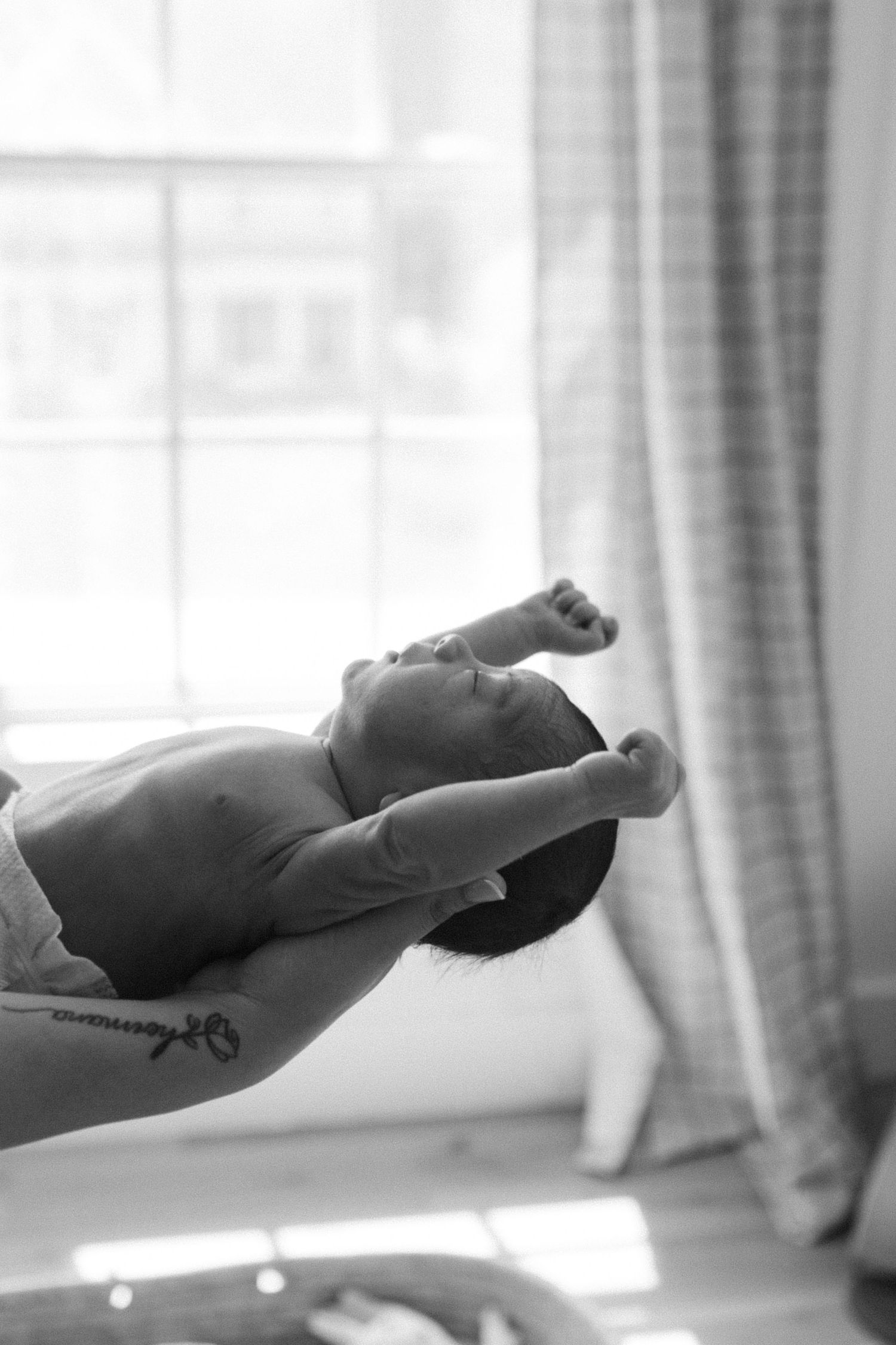 Baby stretching portrait during newborn session in NYC, photo by Paula Brearley NYC newborn photographer