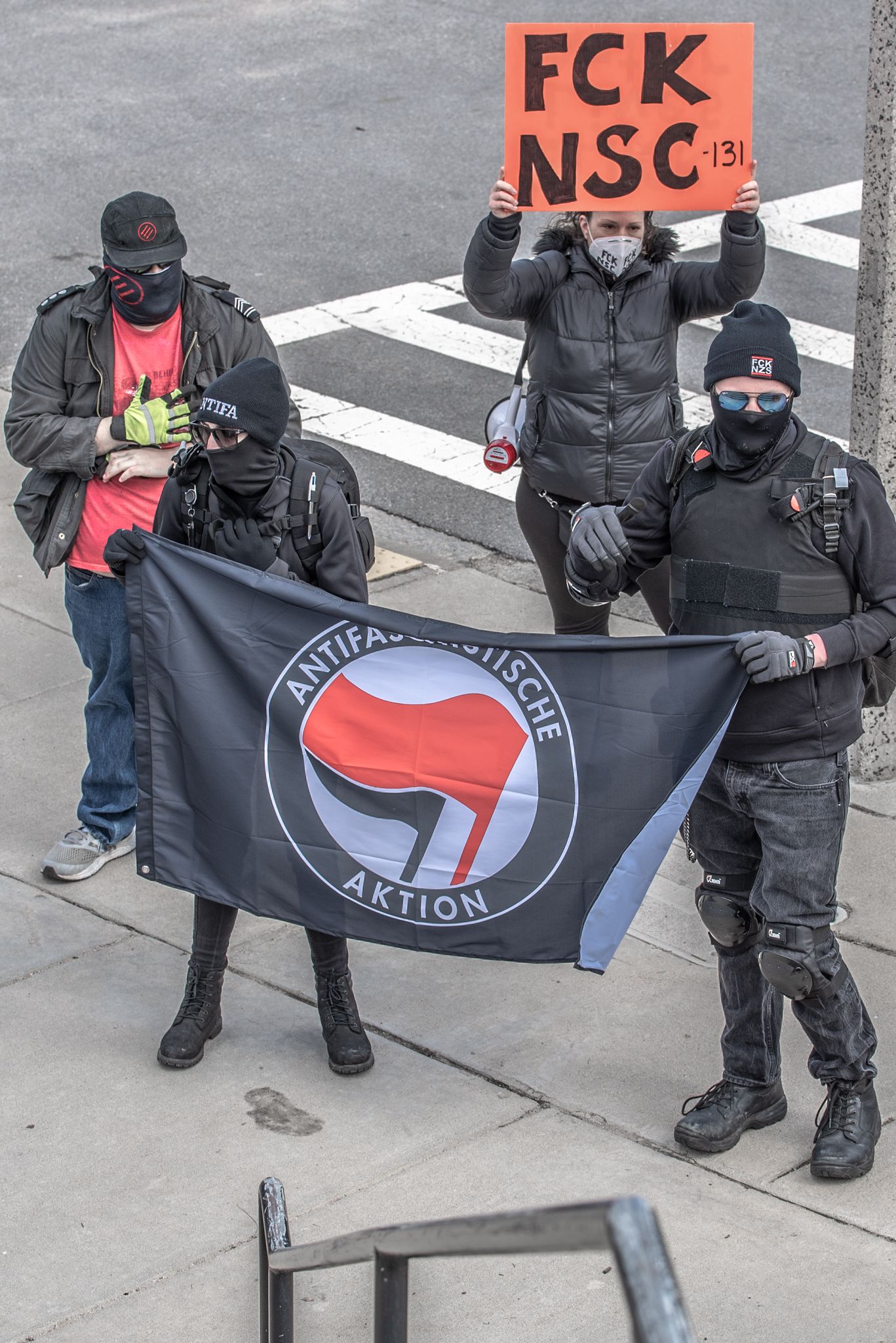 Heidi Hiland with Antifa actvists holding FCK NSC-131 sign.  Photo by Lita Xú Líng Kelley