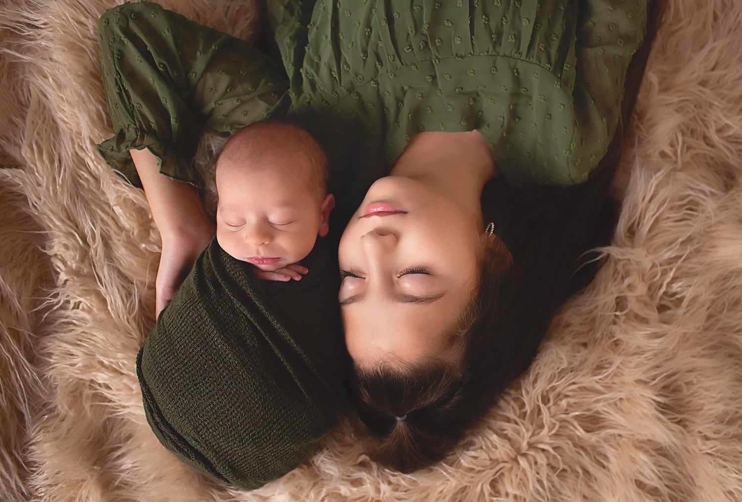 Big sister holding baby brother in studio in Alvin, Tx in-home newborn photography Houston