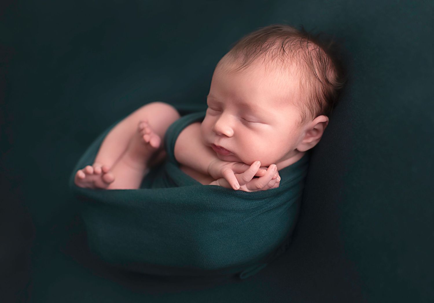 Baby boy wrapped in green at studio in Alvin Tx