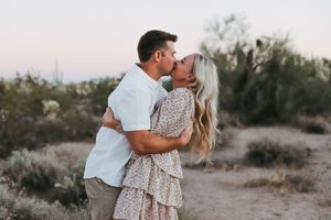 Intimate couple photos in desert landscape with soft lighting.