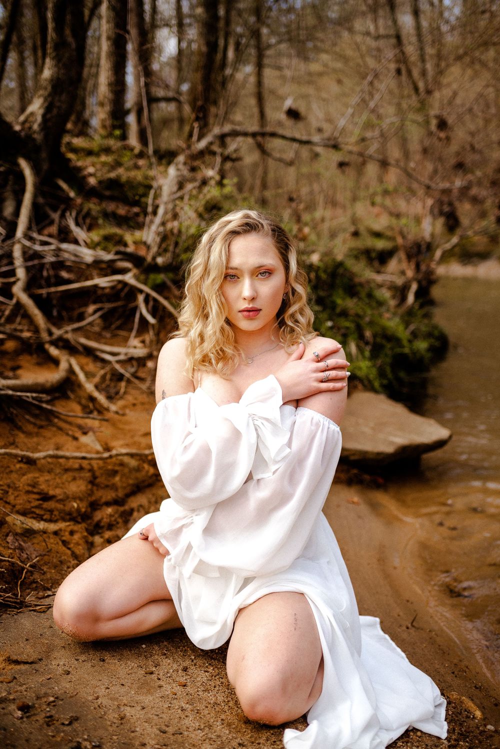 outdoor portrait of woman by creek, empowering session