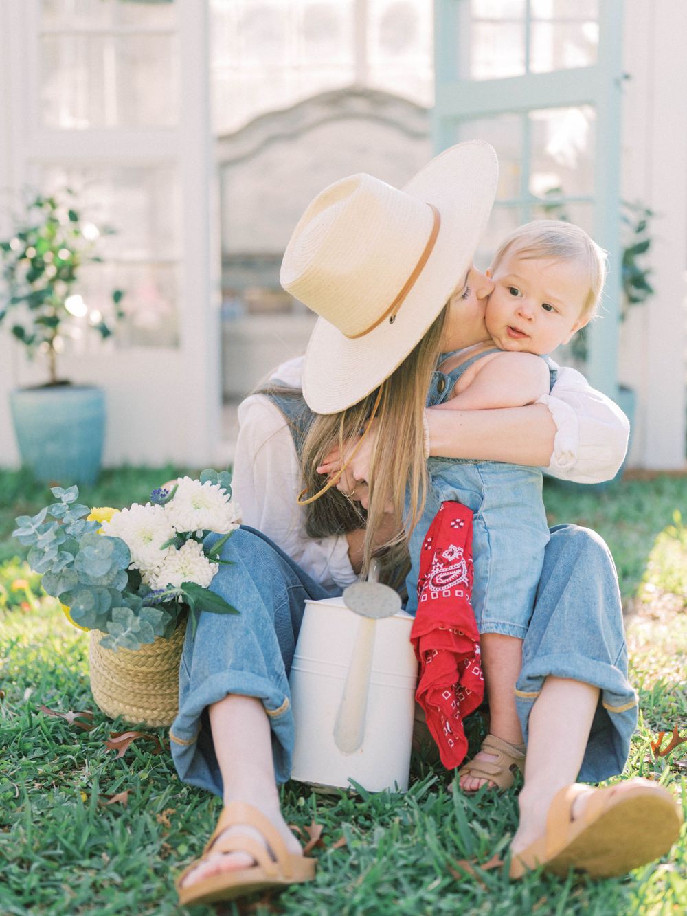 greenhouse petite of a mom kissing her baby boy