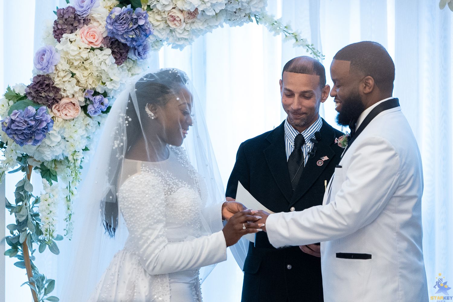 Bride and groom holding hands smiling