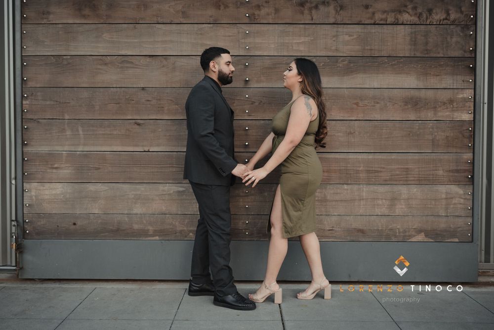 Romantic couple portrait against rustic wooden wall background.