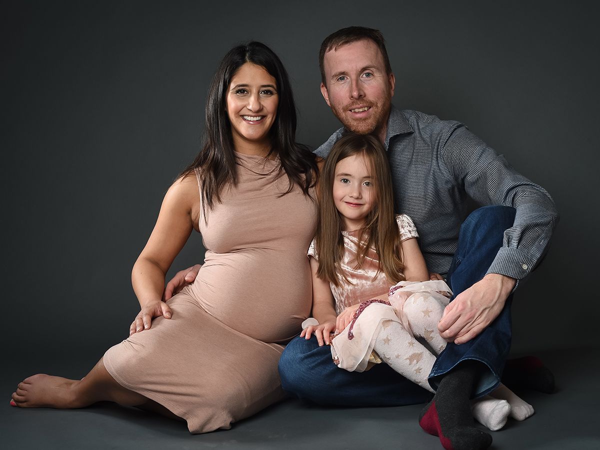 Maternity shoot with family on dark grey background. High Wycombe photo studio Abigail's Studio