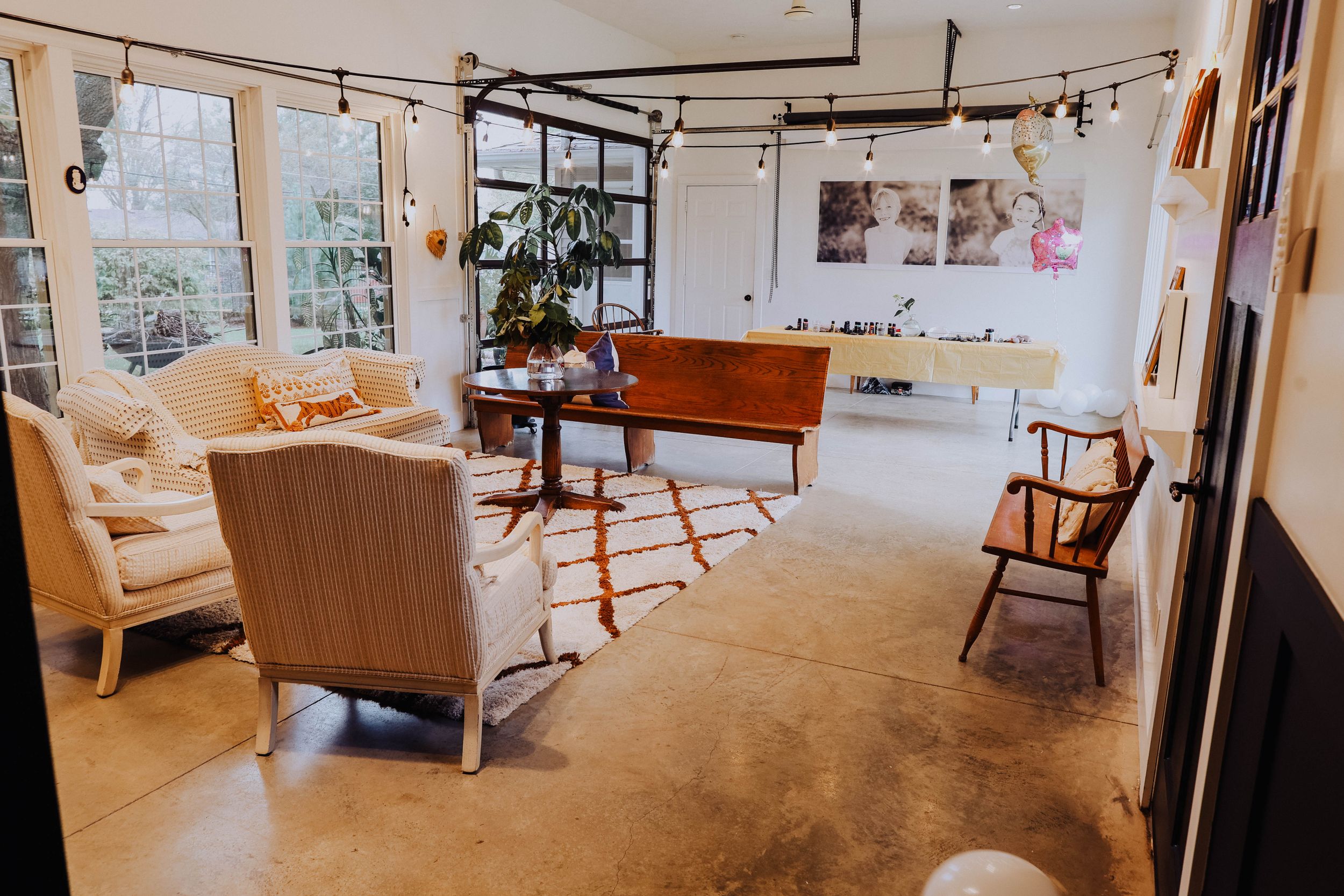 A bright, modern studio space with track lighting and comfortable seating arrangements.