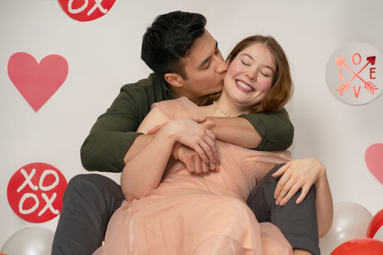 Intimate couple photo with heart decorations and romantic valentines theme.