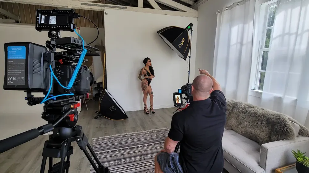 Behind-the-scenes studio photography setup with professional lighting and camera equipment.