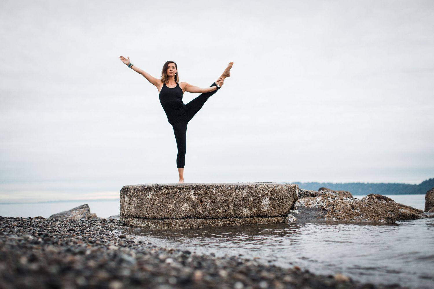 Creative yoga photo of a woman doing yoga on the beach