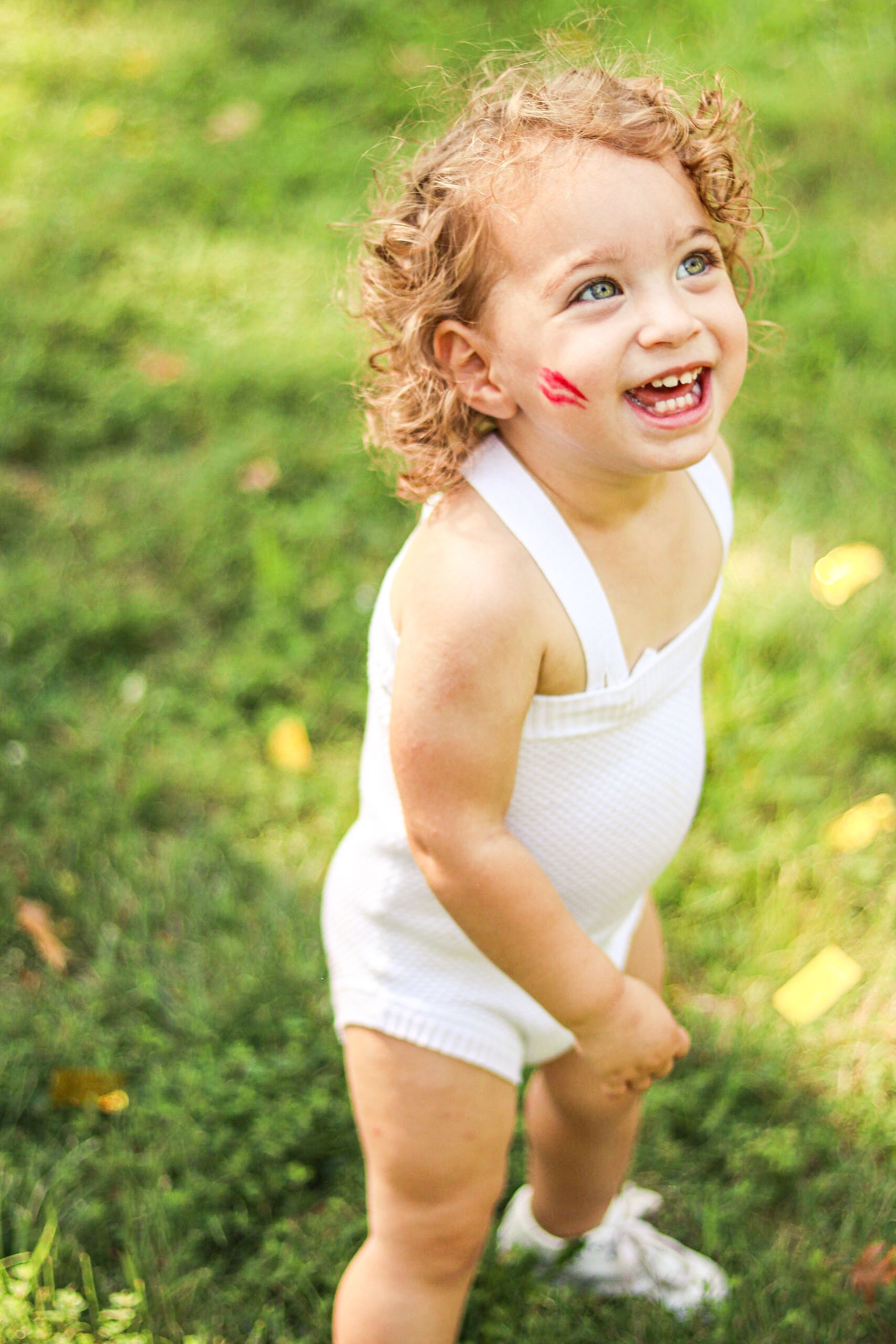 Adorable little boy with curly blonde hair. Photo taken at his two year birthday