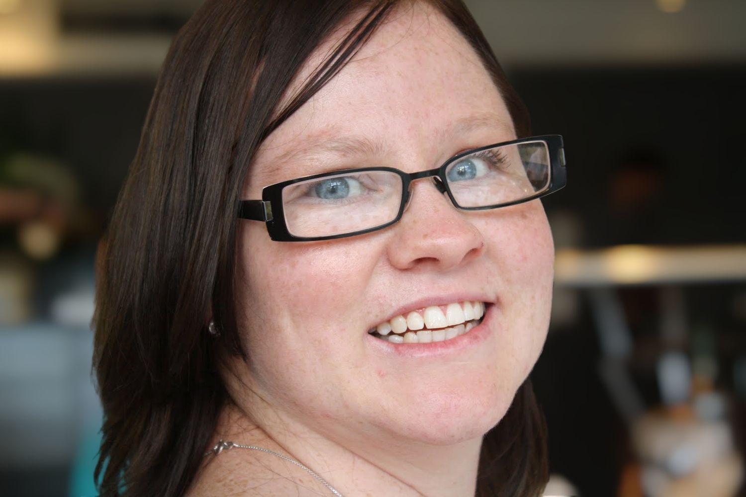 smiling young woman with glasses