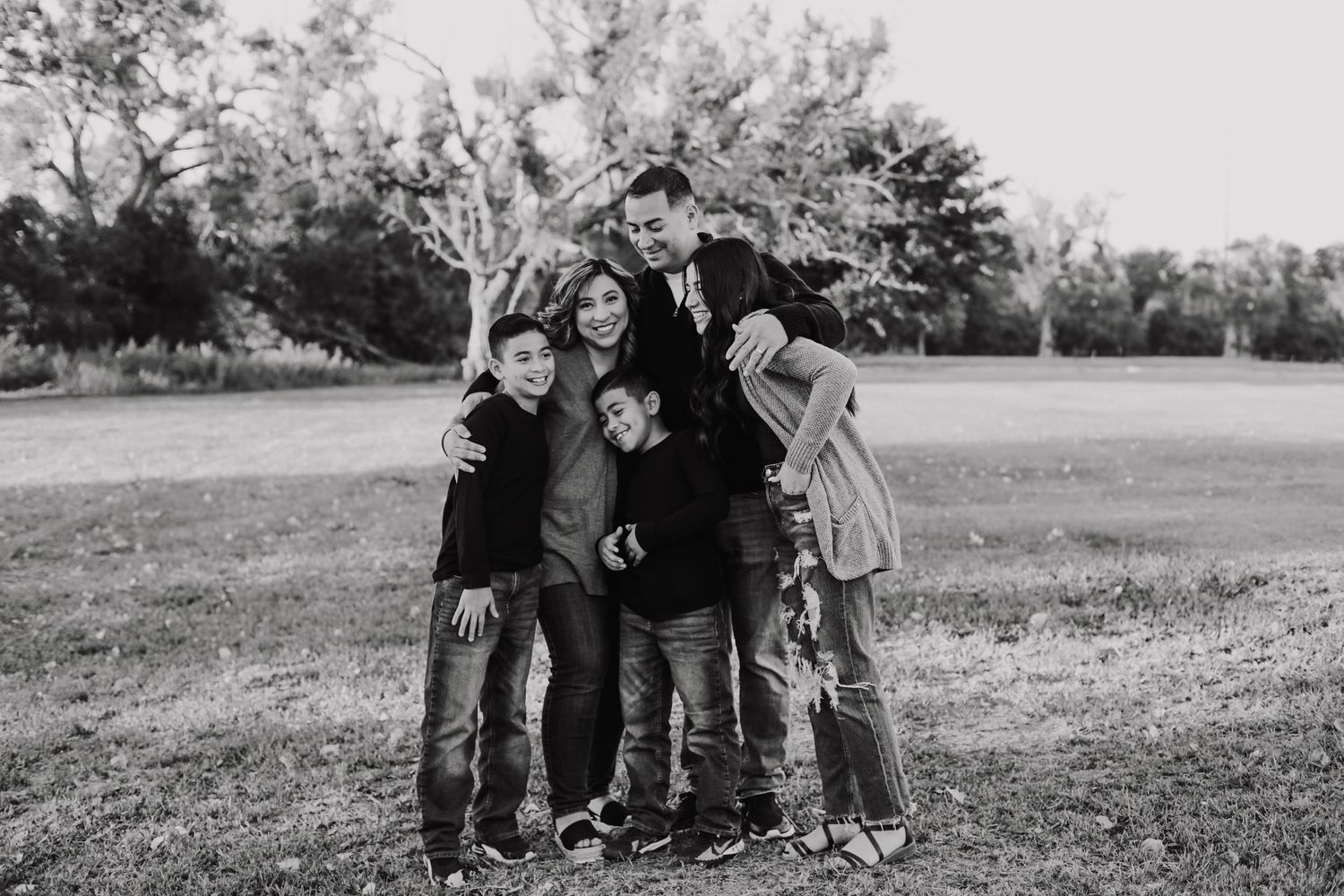 Black and white photo of a family group huddled together outdoors.