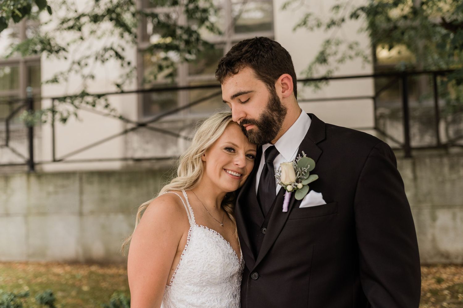 Intimate wedding portrait showing tender moment between newlyweds.