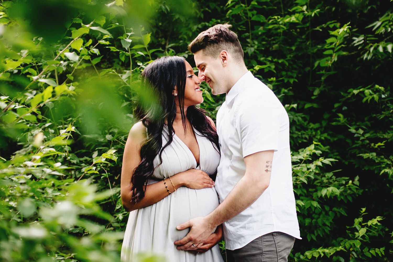 couple about to share a kiss during maternity photo shoot