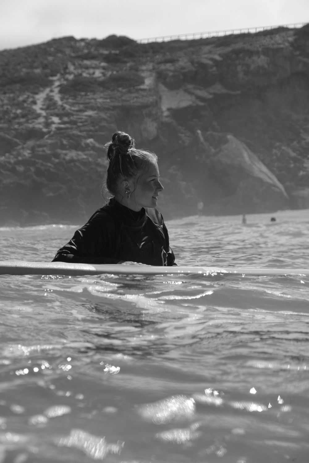 girl captured in water with board black and white
