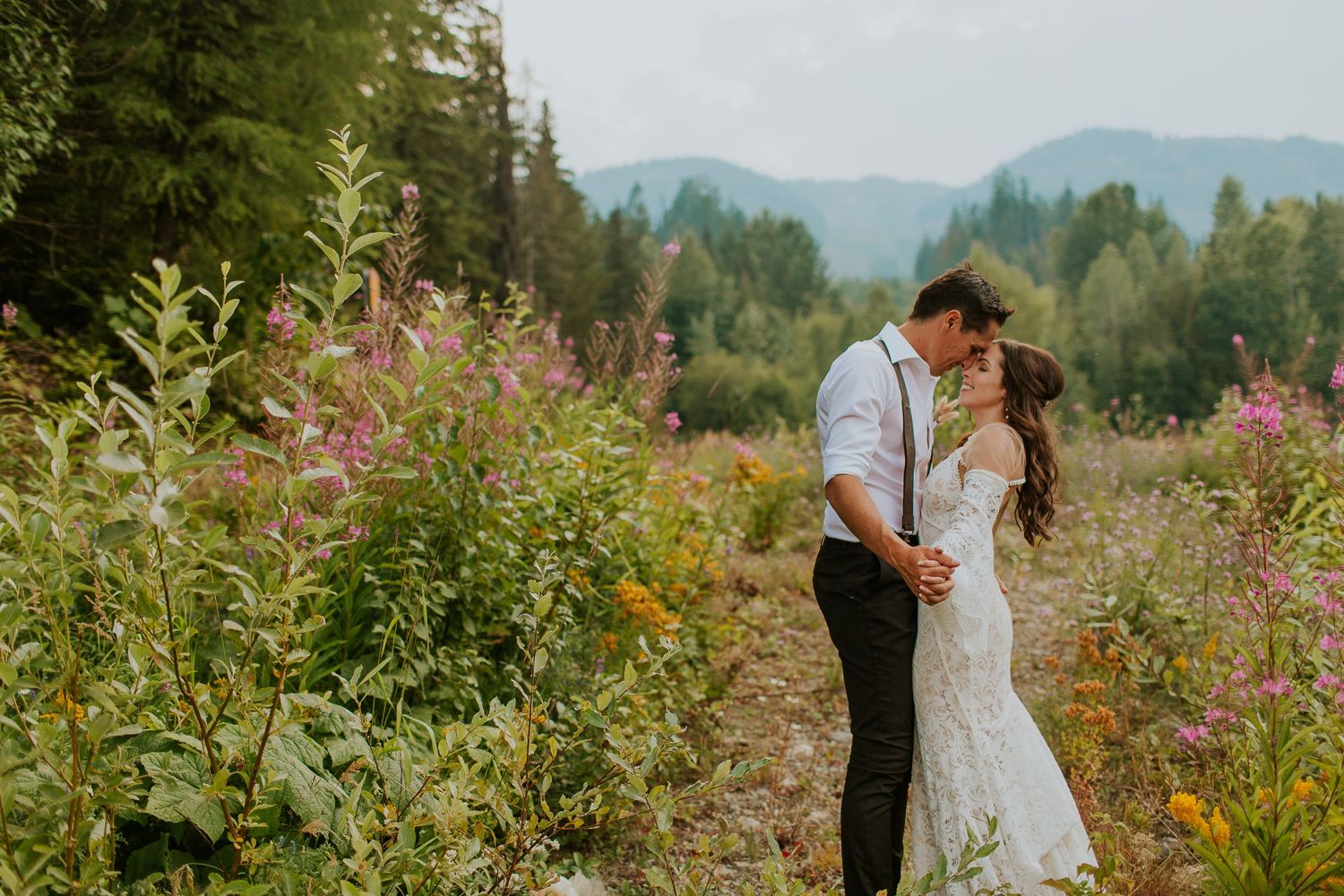 A couple poses on their wedding day on Red Mountain Resort near Rossland BC