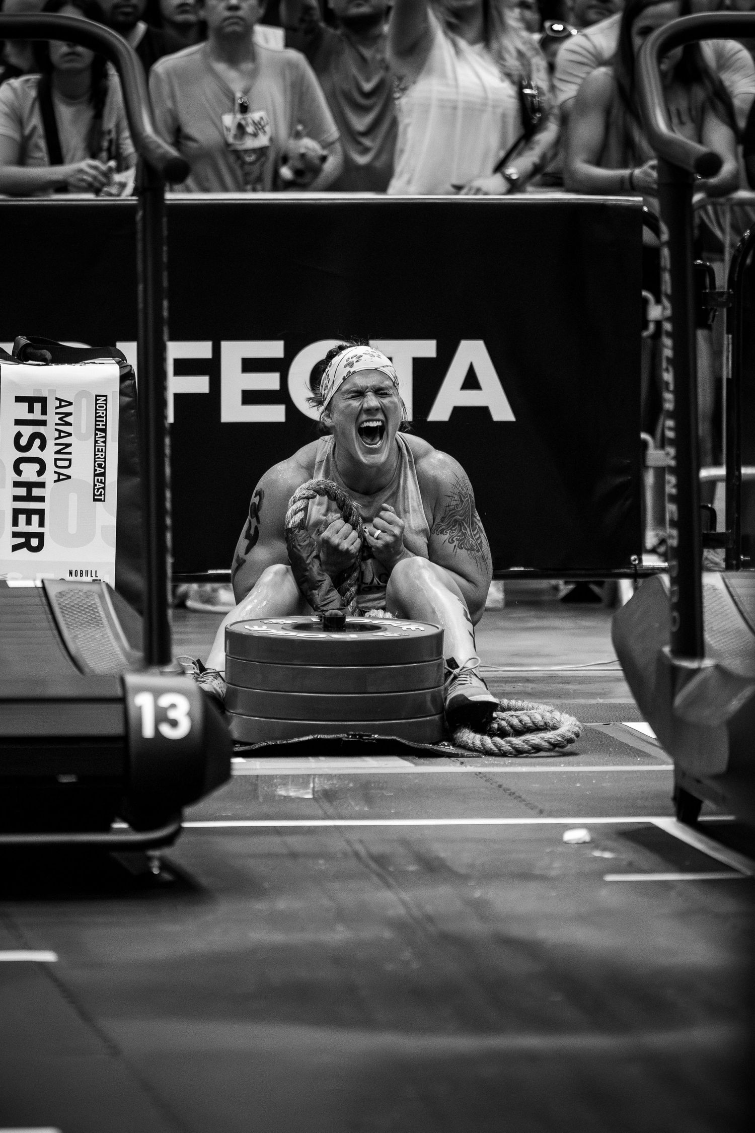 Athlete yelling with intense emotion while competing in a CrossFit competition at station 13.
