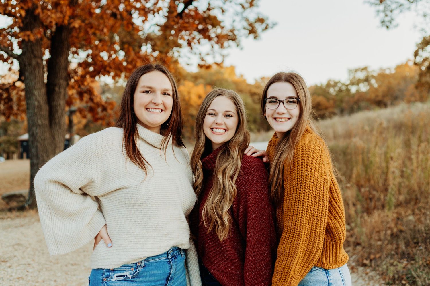 Fall friends photoshoot at lake in Manhattan, Kansas by local family photographer – autumn leaves and candid outdoor photos.