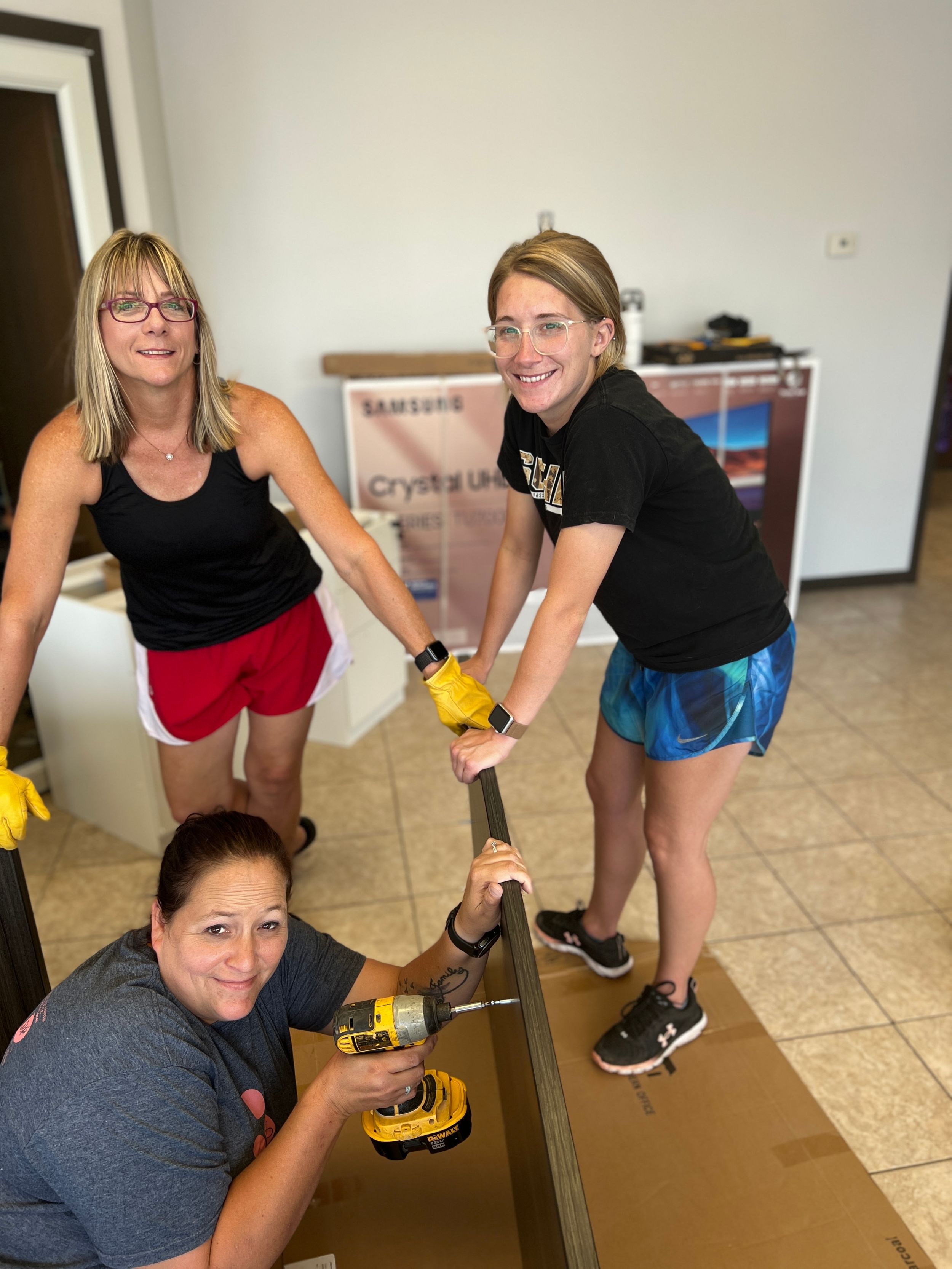 Group working together to install new baseboards in commercial space.