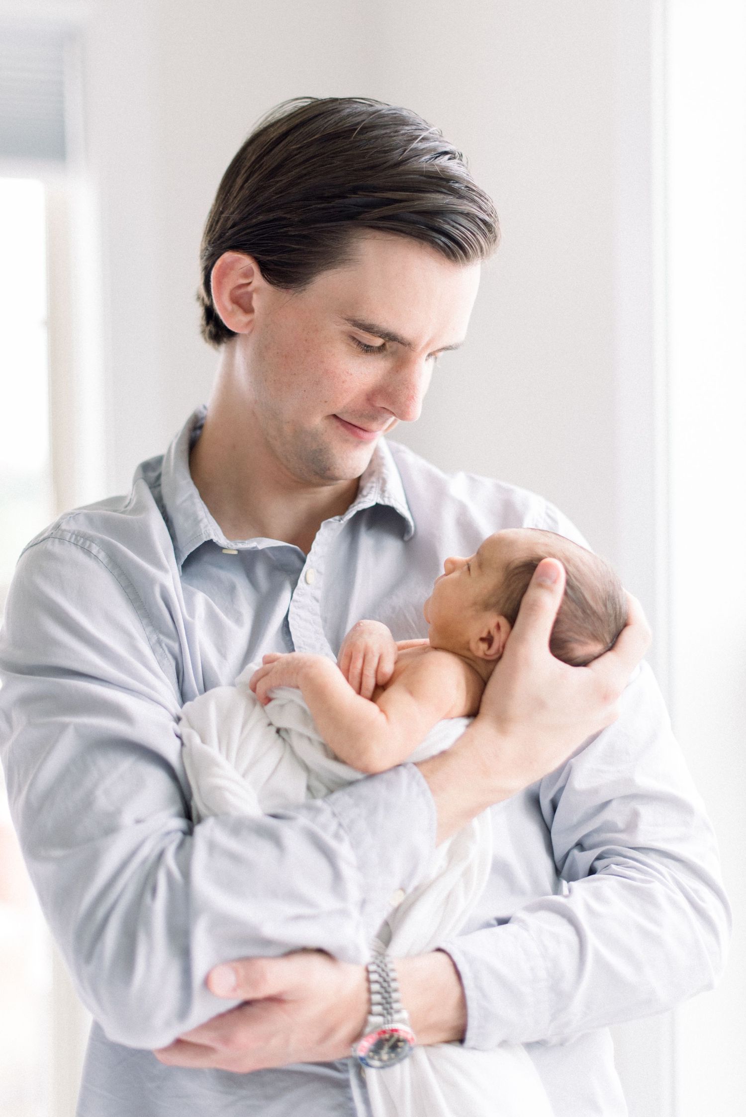 dad holding baby at newborn photo shoot in washington dc