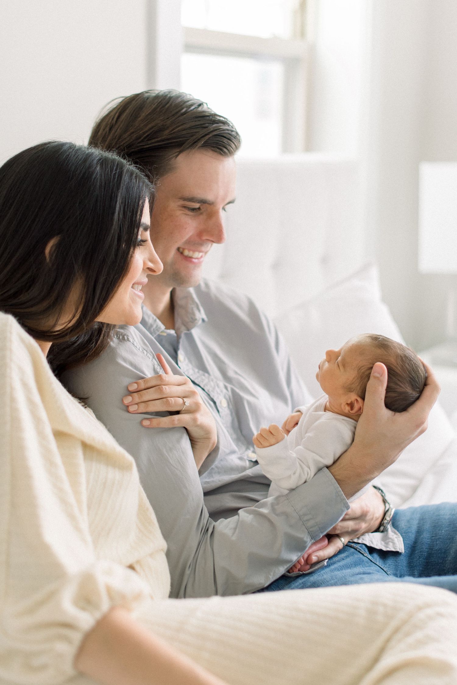mom and dad looking at their newborn